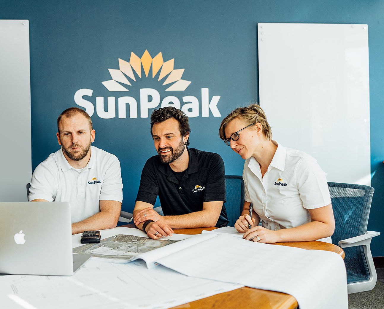 The SunPeak design team in the office, representing SunPeak’s work as an award-winning commercial solar installation company.