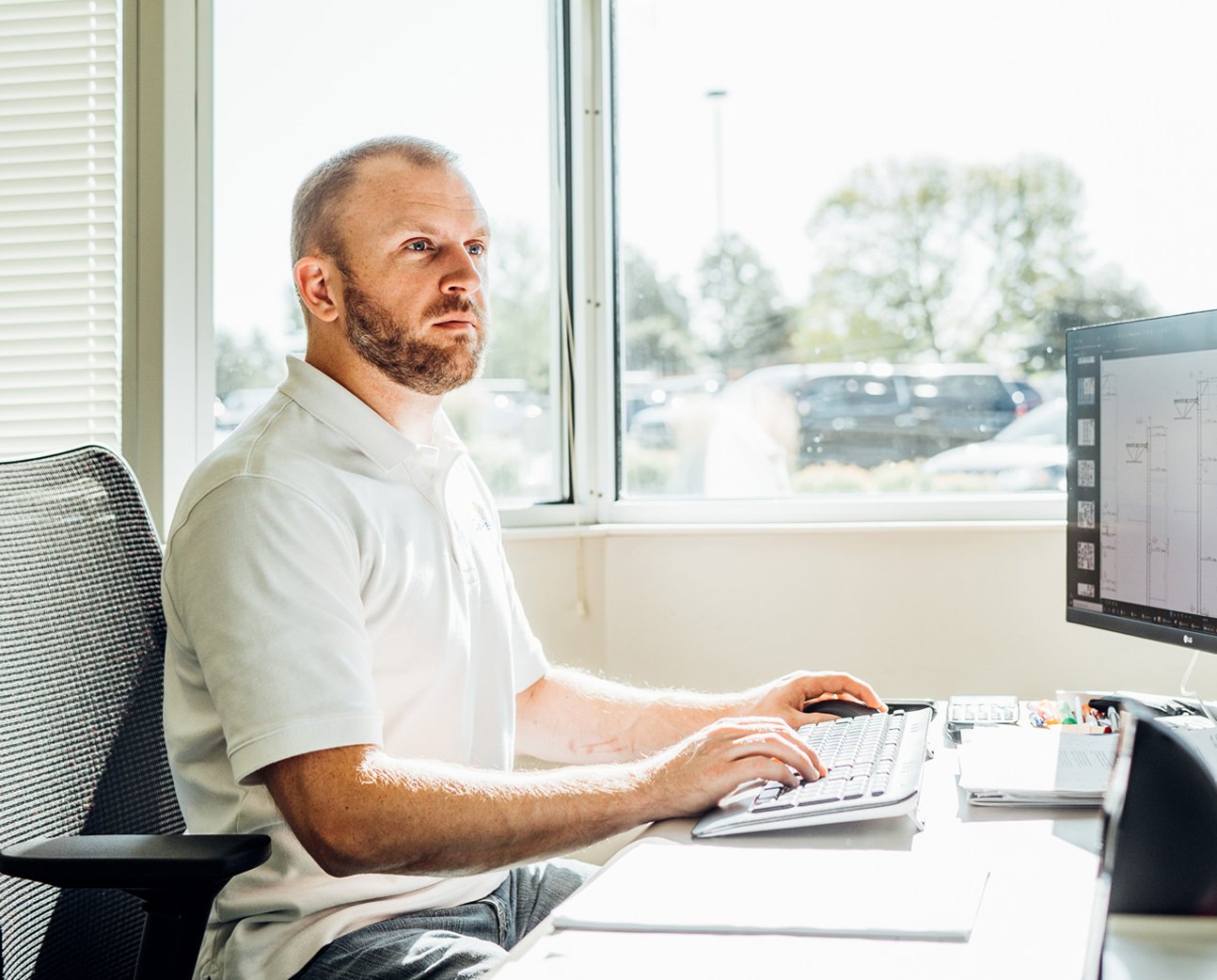 One of SunPeak’s solar design engineers in the office, representing SunPeak’s work as a commercial solar installation company.