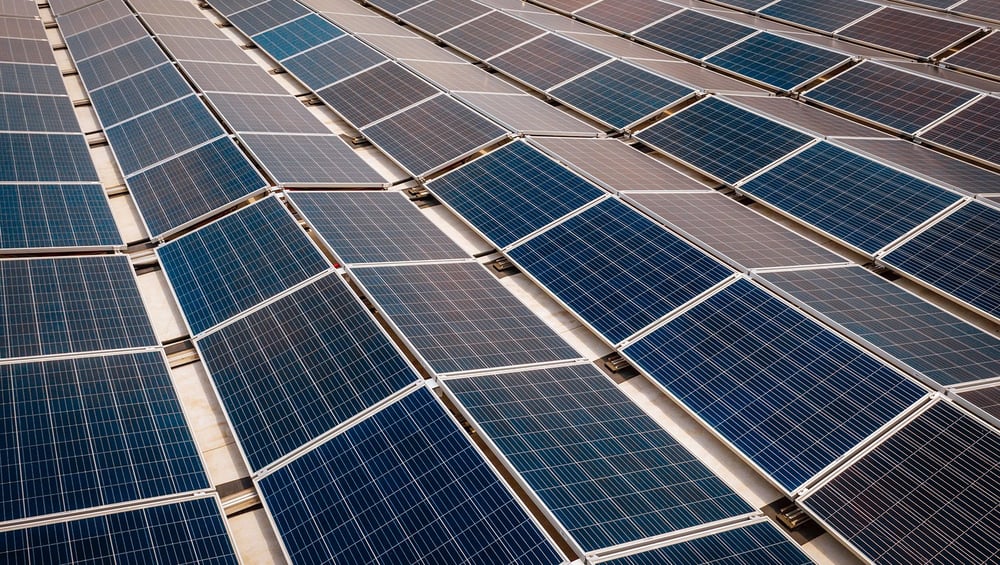 Rows of rooftop solar panels installed by SunPeak, representing solar panel longevity.