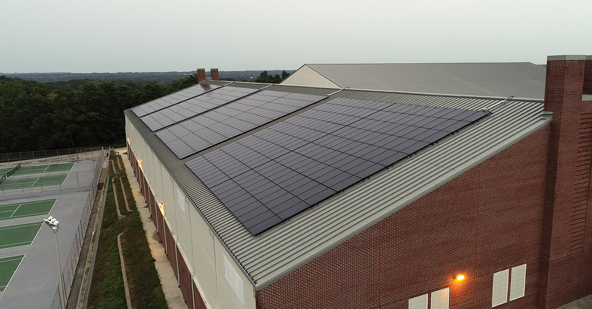 Photo showing solar panels on DePauw University's indoor Track and Tennis Center, representing SunPeak's capabilities as a commercial solar installation company.