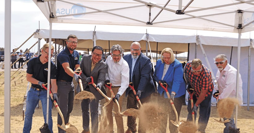 People with shovels representing the groundbreaking of a solar installation